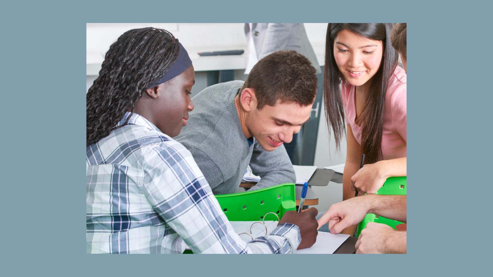 Three middle school students working on a project