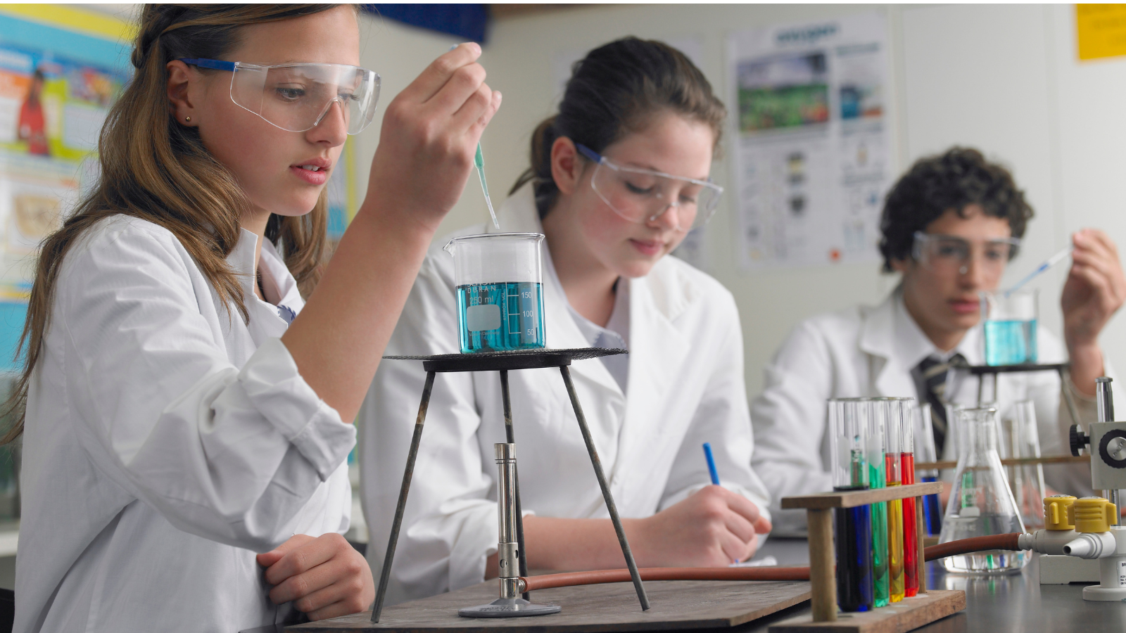 High school students doing chemistry experiment with beakers