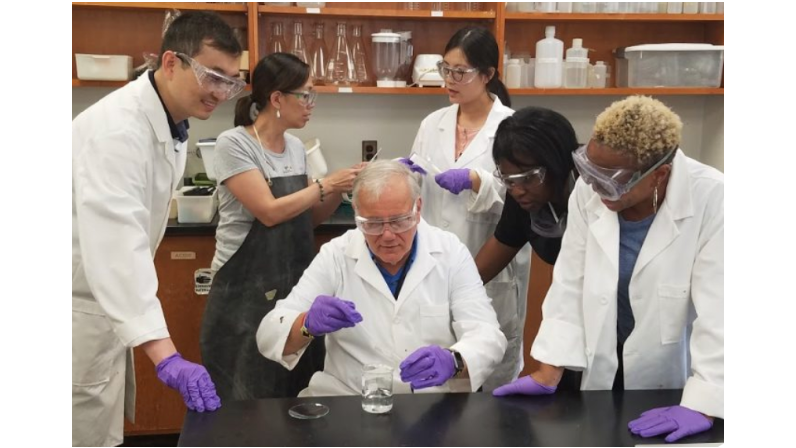 Peng He, Sandy Irwin, Joe Krajcik, Tingting Li, Kalonda McDonald, and Kellie Finnie looking at beakerd 