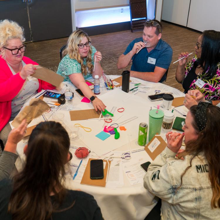 Attendees performing straw exercise