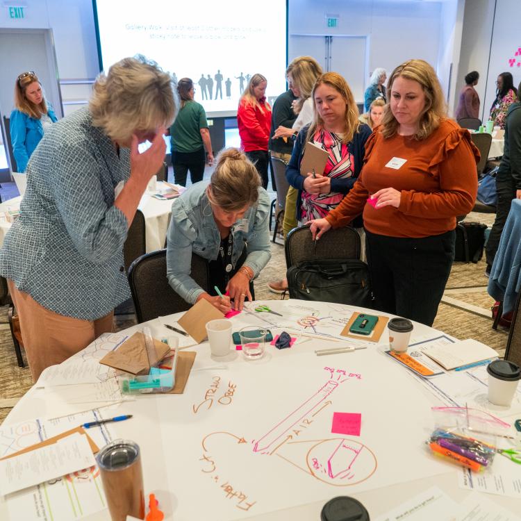 Attendees standing by a table