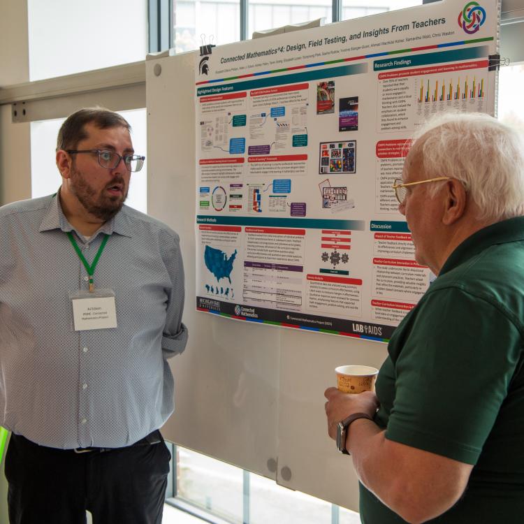 AJ Edson presenting poster to Joe Krajcik