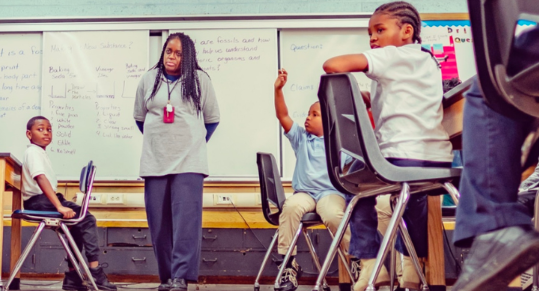 African American teacher teaching ML to students in classroom