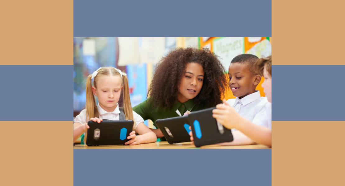 African American female teacher with elementary students looking at devices