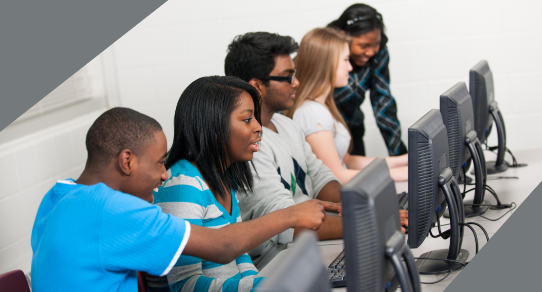 Four students working on laptops