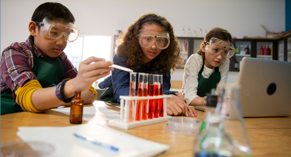 Middle school science students doing experiment with liquids