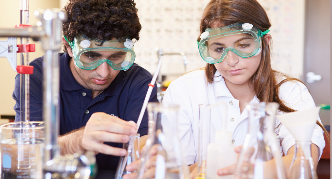 Three middle school students working on a project