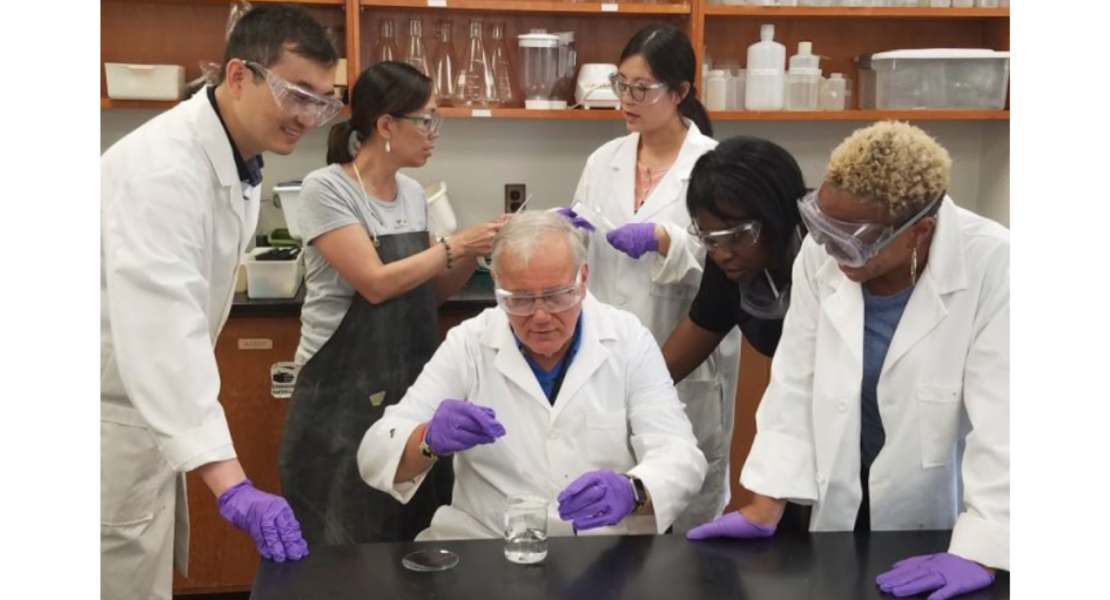 Peng He, Sandy Irwin, Joe Krajcik, Tingting Li, Kalonda McDonald, and Kellie Finnie looking at beakerd 