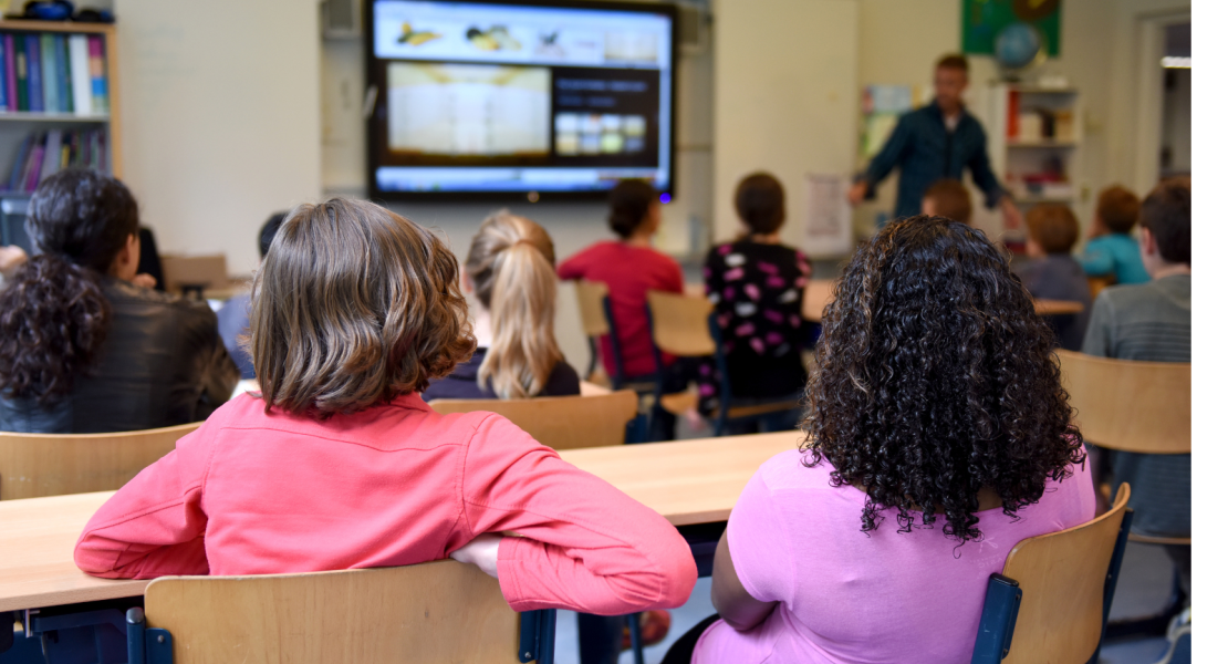 Middle school students looking at teacher