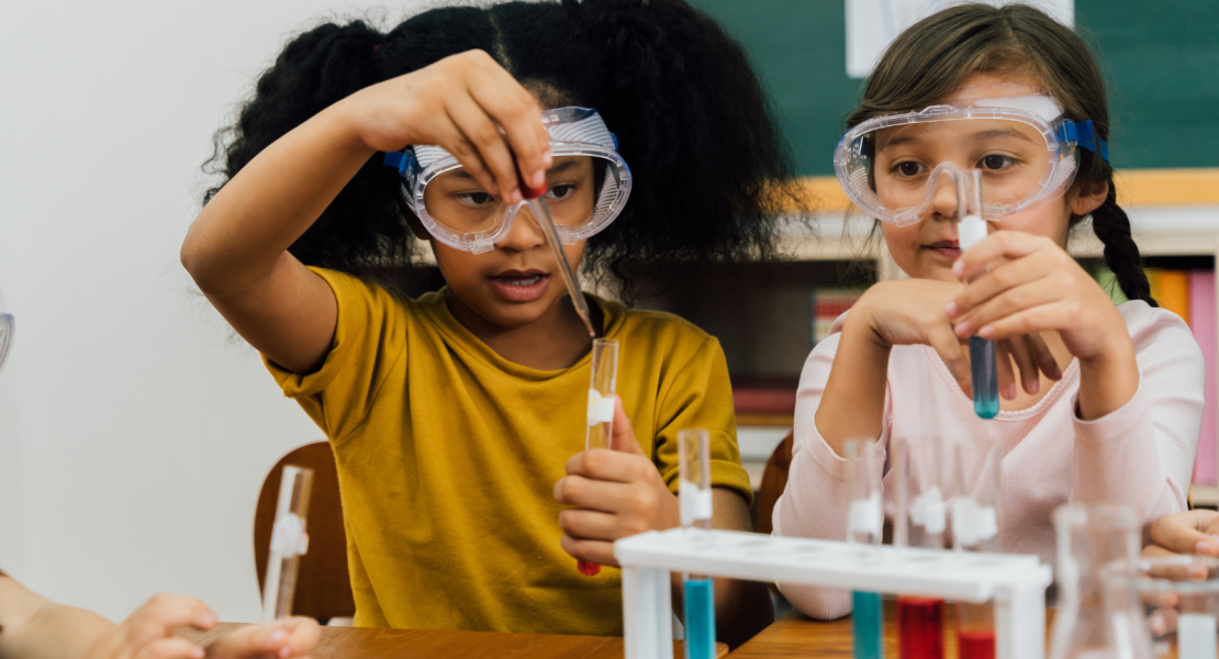 Young female students looking at test tubes