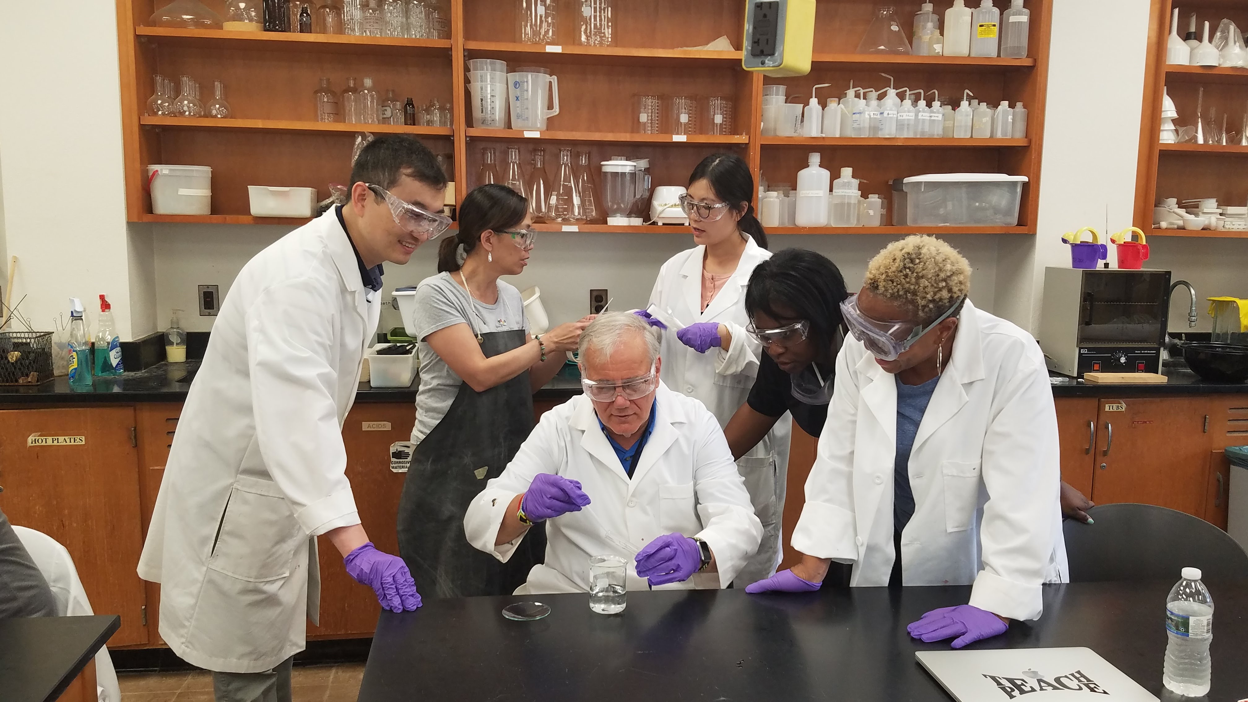 Joe Krajcik in lab surrounded by researchers