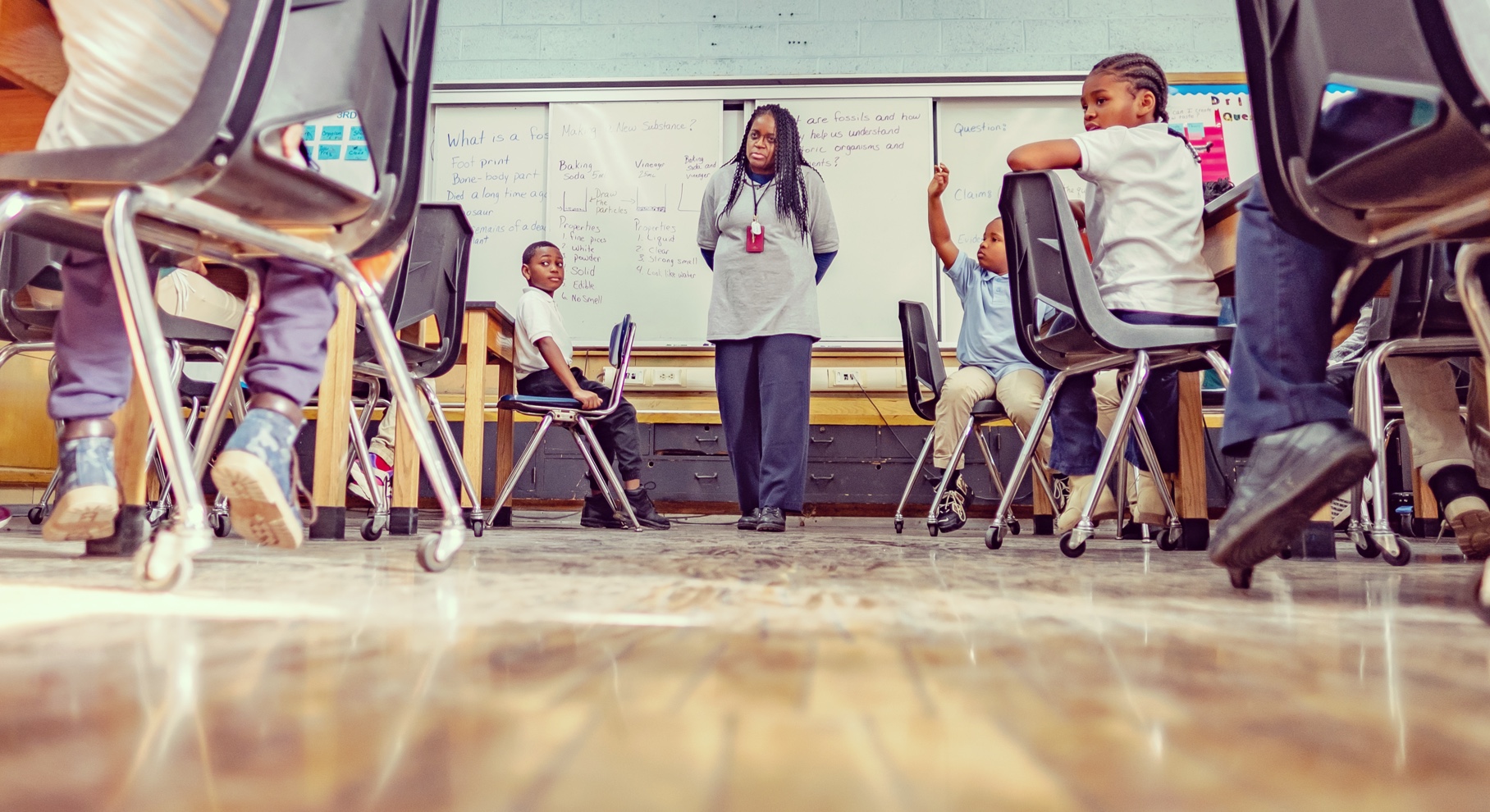 Photo of African-American female teacher in front of classroom of students.