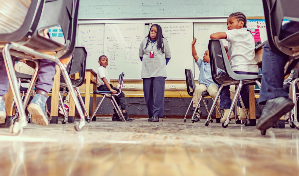 African-American teacher at front of classroom talking with students